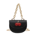 Black mini saddle bag with cherry charm and gold chain straps on white background - Black