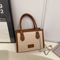 Beige and brown checkered tote bag with top handle and silver chain strap in side view - Khaki