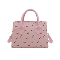 Pink minimalist crossbody bag with red cherry pattern on a clean white background - Pink