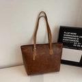Vintage brown leather tote bag with elegant gold hardware and minimalist slogan detail - Brown