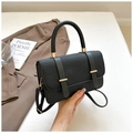 Chic black PU leather handbag with woven texture flap and gold buckles in a lifestyle setting - Black