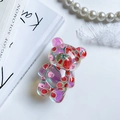 Detail of bear-shaped phone grip with watermelon pattern and purple gradient resin finish - Bear Grip - Laser Fruit - Watermelon