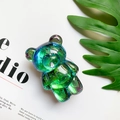 Close-up of a 3D bear phone socket with iridescent sequins and resin finish - Gray