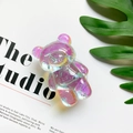 Close-up of translucent purple bear phone socket with glitter flakes on white background - Light Blue