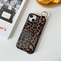 Leopard print phone case with integrated wrist strap handle and gold ring on white desk - Brown Leopard Wristband / iPhone 7/8/SE 2020