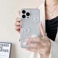 Detailed shot of iPhone case with 3D matte flowers and white pearls held by a model - Transparent Dripping Glue - Three Lotus Flowers / iPhone 7/8/SE 2020