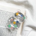 Detailed view of floral resin bear phone grip on vintage book background - Multi-color Floral