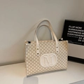 Classic white tote bag with repeated M-pattern prints and embossed round logo detail - Off White