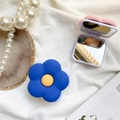 Close-up of floral folding makeup mirror phone grip in navy blue and pink styles - Blue