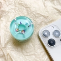 Detail shot of mint green doughnut phone grip with colorful sprinkles on a beige background - Light Green