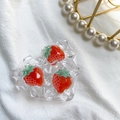 Macro detail of heart-shaped resin phone grip with 3D strawberry ice texture on fabric - Ice Fruit - Strawberry