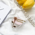 Close-up of heart-shaped phone grip featuring a rose gold flower and romantic message - Pink
