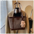 Detail of embossed cat pattern on brown suede tote bag with plush puppy pendant - With Charm / Brown
