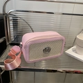 Pink leather and beige woven crossbody camera bag with silver M logo on a modern shelf - Pink
