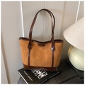 Detail of tan suede tote bag with dark brown patent leather trim and embossed logo pattern - Brown No Pendant