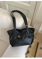 Close-up of black retro minimalist tote bag with belt buckle detail on a white sofa - Black