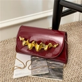 Elegant wine red patent leather crossbody bag with gold wavy trim and chain strap - Dark Red