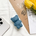 Detail of cute dark blue bear foldable phone grip stand on a white smartphone back - Ink Blue
