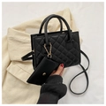 Detail of black quilted crossbody bag with matching coin purse and golden hardware - Black