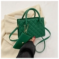 Detail of green quilted tote bag with matching coin purse and gold chain hardware - Green