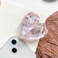 Macro shot of heart-shaped phone griptok with colorful sequins and diamond texture - Pink