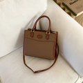 Retro caramel brown rectangular tote bag on sofa with adjustable shoulder strap - Tan