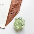 Gros plan d'un support de téléphone patte de chat vert clair avec des paillettes brillantes - Vert clair