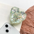 Detail of 3D faceted heart phone socket with iridescent sequins on a white background - Green