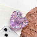 Macro detail of a 3D purple heart phone socket with sparkling glitter and sequins - Purple