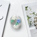 Detailed close-up of a clear tulip flower phone grip on an aesthetic lifestyle background - White Blue Camellia (Round)
