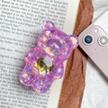 Détail du support de téléphone ours pailleté violet avec cœur doré sur un livre - Violet foncé