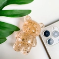Dettaglio del supporto per telefono a forma di orso con foglia d'oro su uno smartphone - Arancione Trasparente