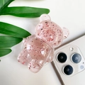 Dettaglio del supporto per telefono a orso rosa trasparente con glitter e argento - Rosso Trasparente