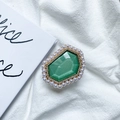 Close-up of green hexagonal gemstone phone stand with pearls and rhinestones - Light Green