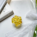 Detail of yellow faceted gemstone phone socket holder on white lace and floral background - Yellow Crushed Ice