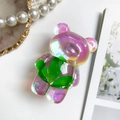 Détail du support téléphone ours 3D avec finition laser irisée et motif de feuille - Fleur réelle irisée-Grand trèfle
