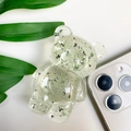 Macro detail of transparent bear phone grip with silver foil and green flakes - Transparent Green
