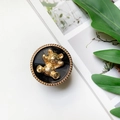 Detailed macro view of the vintage electroplated gold bear phone ring stand with black texture - Gold Ring Stand-Fat Bear-Textured Black