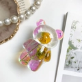 Detail view of colorful laser bear phone stand with embedded real dried flowers - Iridescent Real Flower-Sunflower Daisy