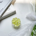 Detail of round mint green collapsible phone grip with crystal texture on white desk - Neon Yellow Crushed Ice