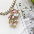 Detailed macro view of iridescent pink bear phone socket with embedded dried flowers - Iridescent Real Flower-Little Grass