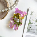 Detail of bear-shaped phone grip featuring colorful resin and embedded dried flowers - Iridescent Real Flower-Little Daisy