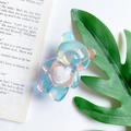 Close-up of holographic bear phone socket with white plush heart and aurora finish - Bear with Heart / Aurora Blue