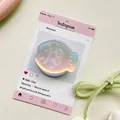 Macro view of fish-shaped iridescent phone grip on a creative display card - Magnetic Matte Taiyaki / Blue Laser