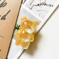 Macro detail of bear-shaped holographic phone grip with yellow glitter resin - Laser Glitter Yellow
