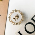 Detailed close-up of a vintage-style gold phone socket with pearls and rhinestones - White