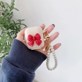 Ivory AirPods case featuring a large red 3D bow and elegant pearl bead chain strap - Beige Case Red Bow (Pearl Chain) / Compatible with AirPods 1/2 Gen