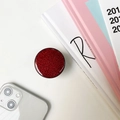 Runde Handyhalterung mit rotem Glitzer-Finish auf einem minimalistischen Schreibtisch - Rot