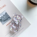 Detail view of transparent bear phone grip with sparkling colorful sequins and stars - Pink
