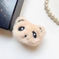 Close-up of cute plush panda phone grip with soft fur texture and black embroidery - Almond Bear